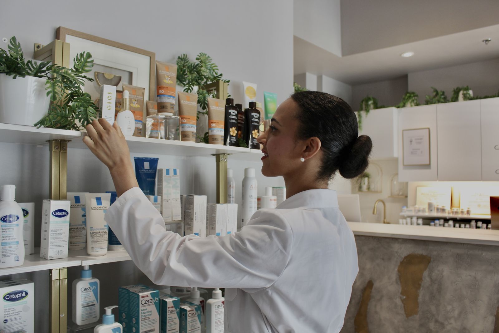 Pharmacist reaching for a product on the Cunard dispensary shelf